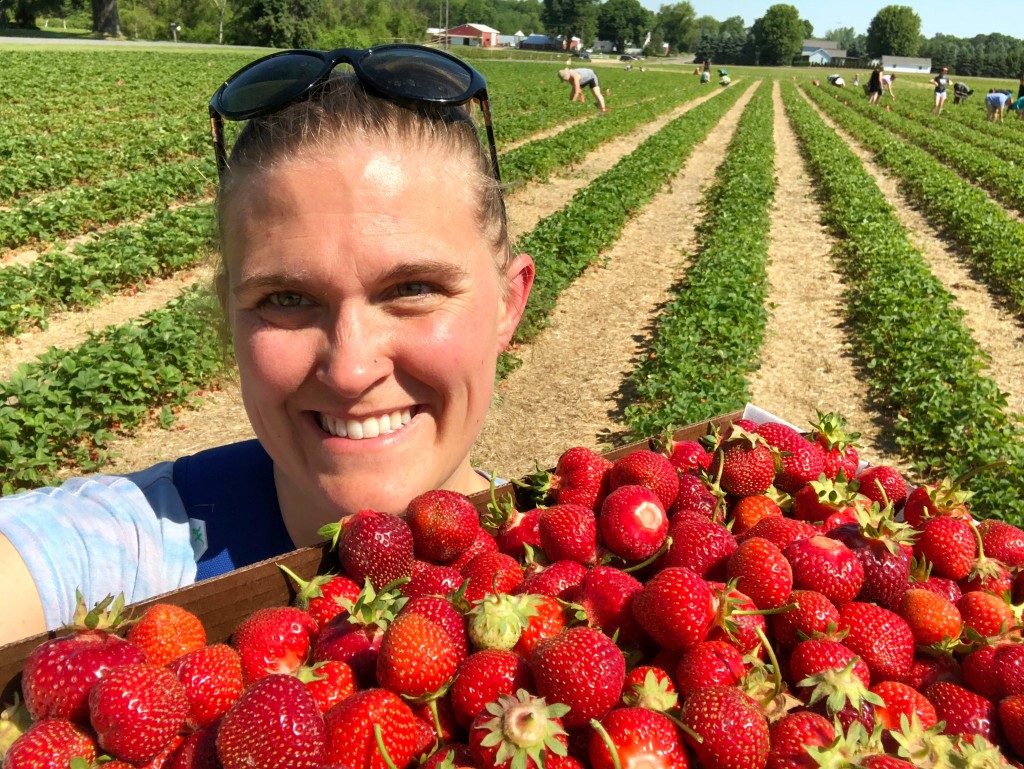 Me, holding a big flat of strawberries in the U-pick field