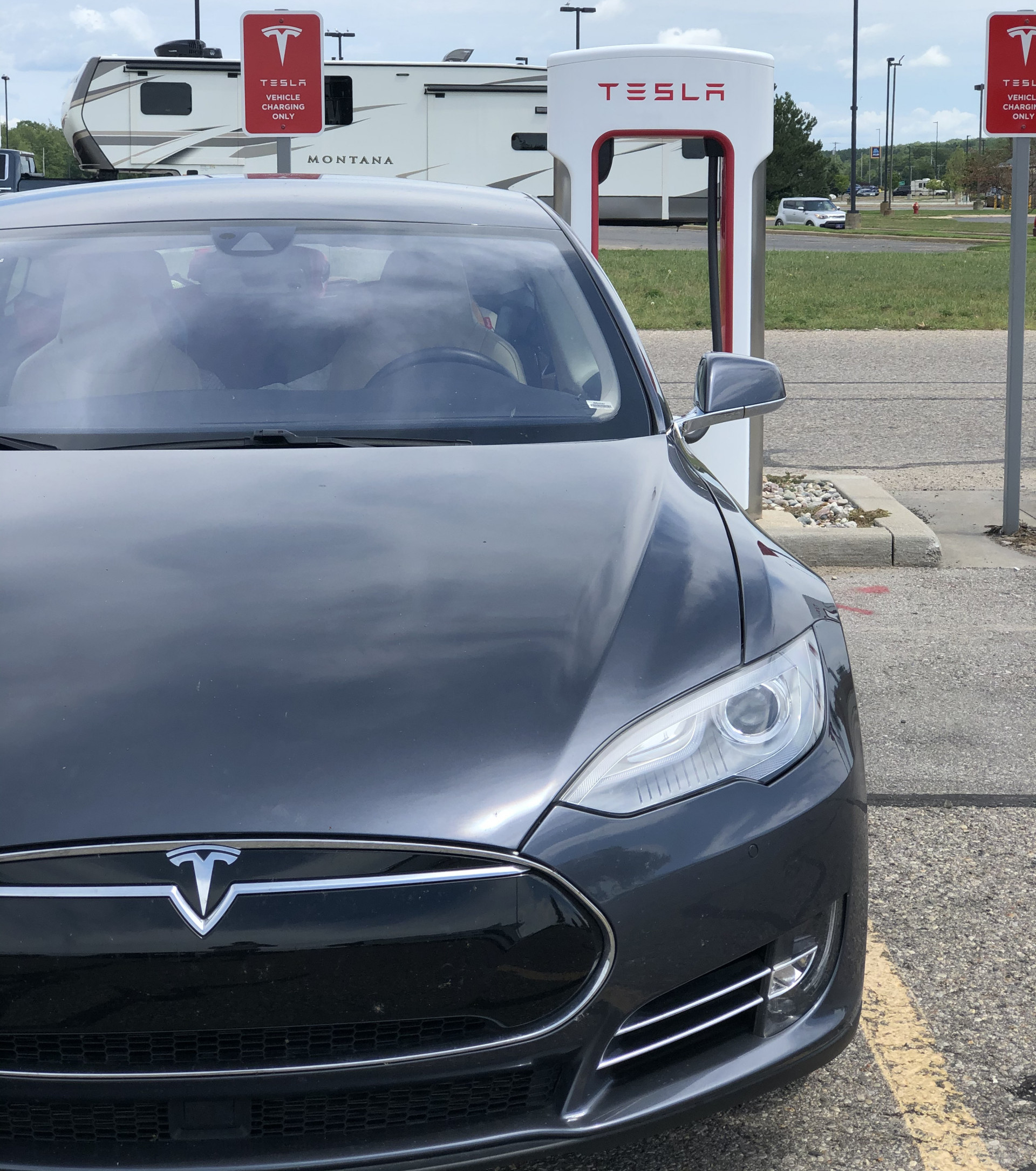 My 2015 Tesla, Model S, parked at a supercharging station